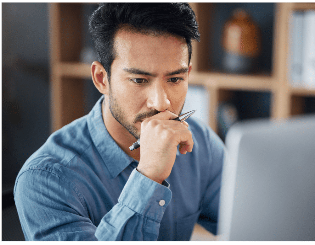 businessman looking at computer reading the nec end of life pbx systems news